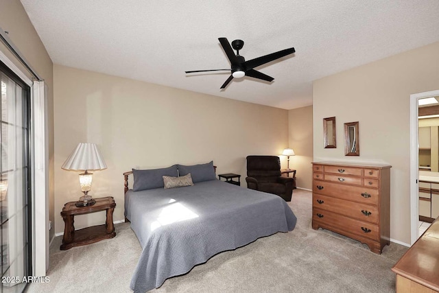 carpeted bedroom featuring ceiling fan, connected bathroom, and a textured ceiling