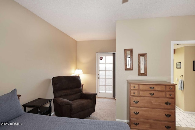 bedroom featuring light carpet and a textured ceiling