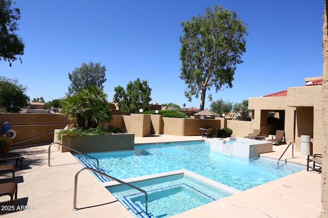 view of swimming pool featuring an in ground hot tub and a patio area