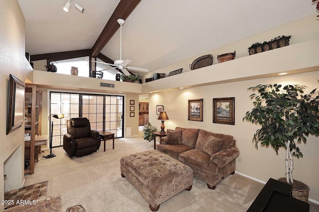 living room featuring ceiling fan, high vaulted ceiling, light colored carpet, and beam ceiling