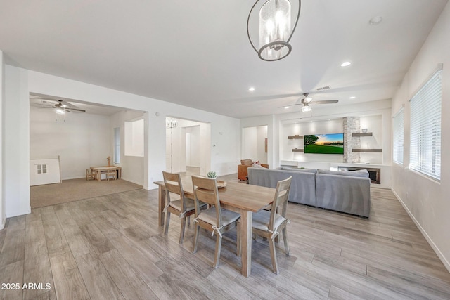 dining room with ceiling fan, visible vents, and light wood-type flooring