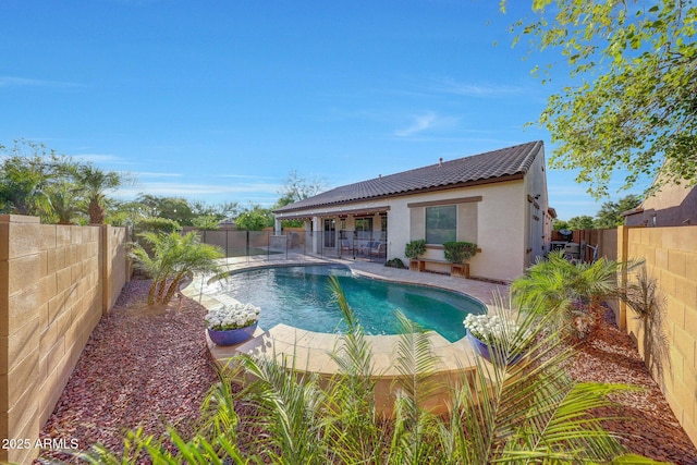 view of pool featuring a fenced backyard, a fenced in pool, and a patio