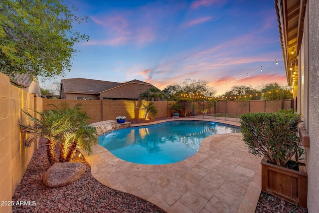 pool at dusk featuring a fenced in pool, a fenced backyard, and a patio area