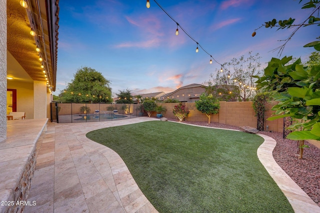view of yard with a fenced in pool, a fenced backyard, and a patio