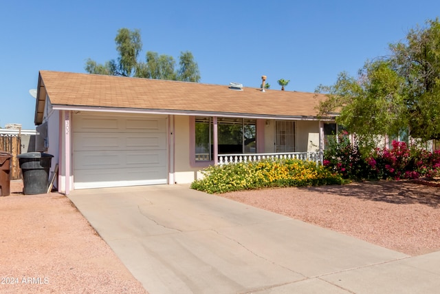 ranch-style house with covered porch and a garage