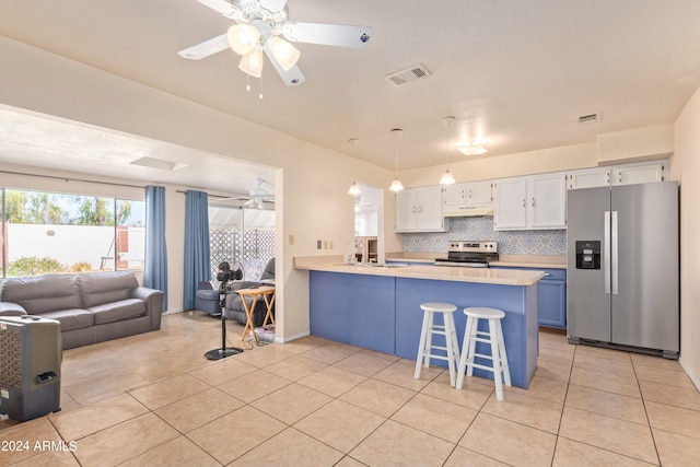 kitchen featuring stainless steel appliances, kitchen peninsula, hanging light fixtures, a kitchen bar, and white cabinetry