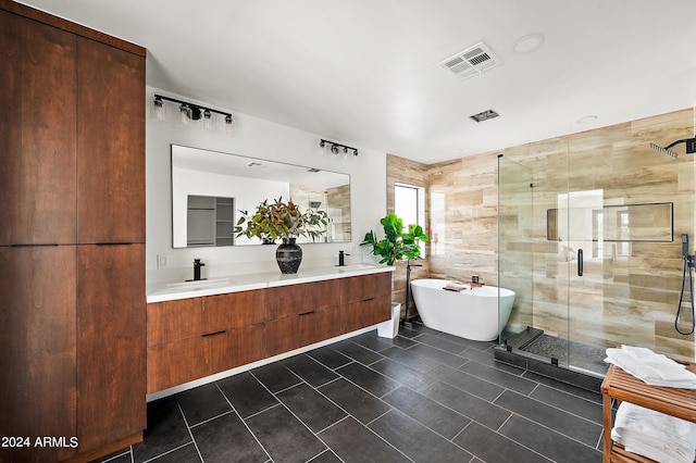 bathroom featuring tile patterned flooring, vanity, and separate shower and tub