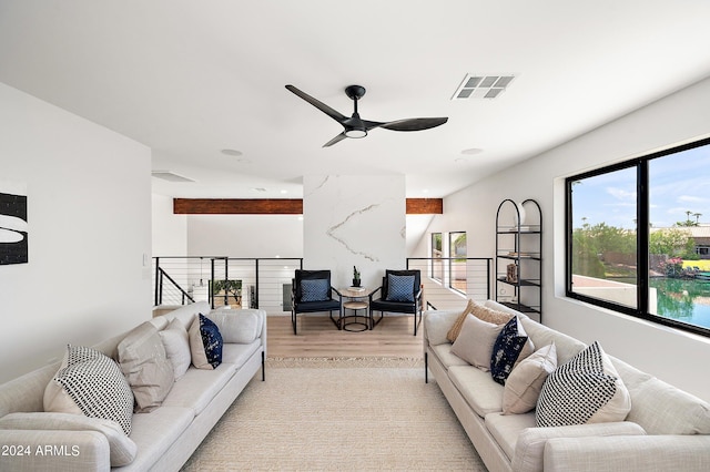 living room with light wood-type flooring and ceiling fan