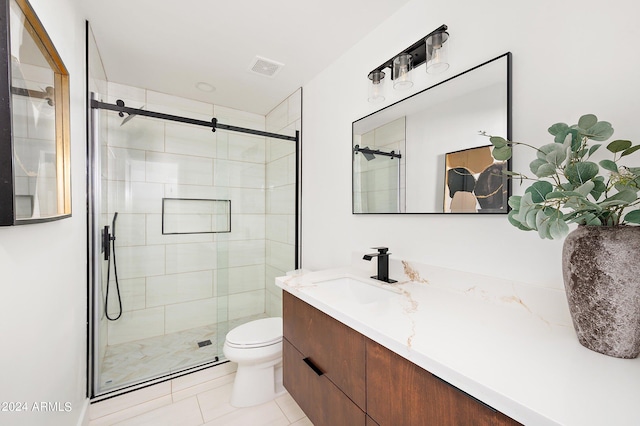 bathroom with tile patterned floors, an enclosed shower, vanity, and toilet