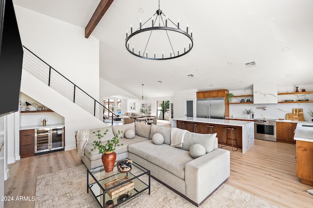 living room with light hardwood / wood-style flooring, beam ceiling, high vaulted ceiling, and an inviting chandelier