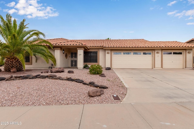 view of front facade with a tiled roof, a garage, driveway, and stucco siding