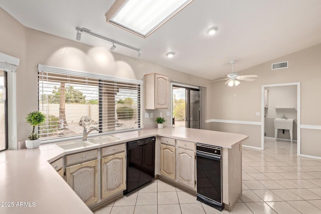 kitchen featuring visible vents, a sink, black dishwasher, a peninsula, and light countertops