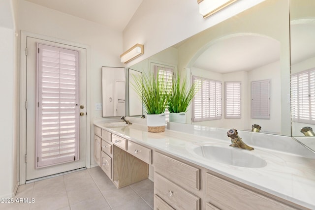 bathroom featuring tile patterned floors, double vanity, and a sink