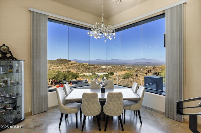 dining room featuring visible vents, tile patterned flooring, a mountain view, and a notable chandelier