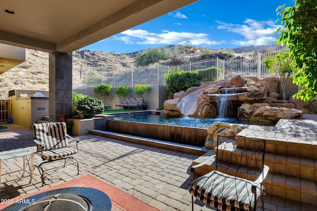 view of patio / terrace with a fenced backyard and a mountain view