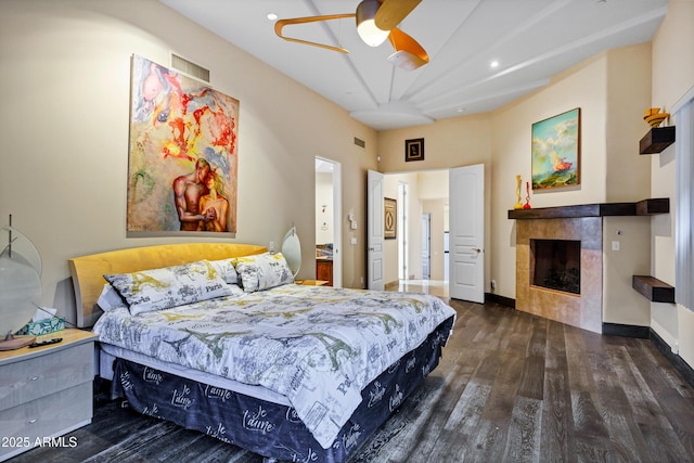 bedroom with recessed lighting, visible vents, a fireplace, and wood finished floors