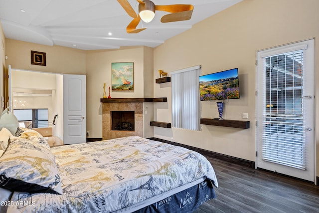 bedroom with baseboards, ceiling fan, wood finished floors, access to outside, and a fireplace