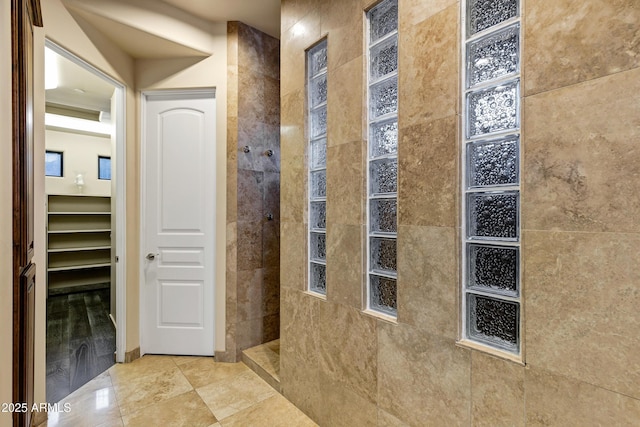 bathroom featuring a walk in shower and tile patterned floors