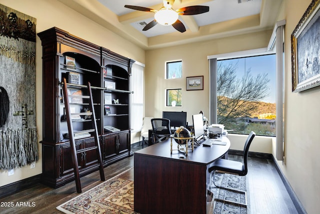 office featuring dark wood-style floors, ceiling fan, visible vents, and baseboards