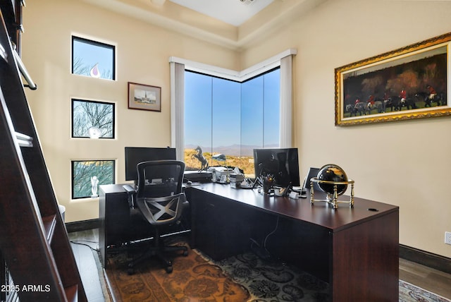 office area with baseboards and wood finished floors