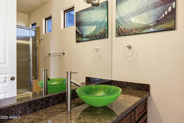 bathroom featuring an enclosed shower and vanity