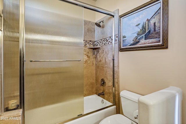 full bathroom featuring toilet and shower / bath combination with glass door