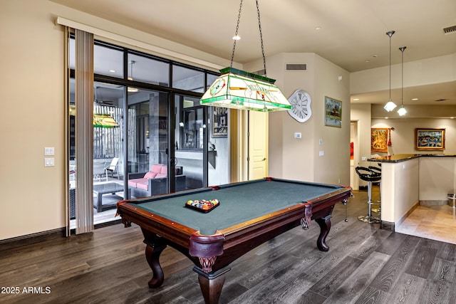 recreation room featuring baseboards, visible vents, and dark wood-type flooring