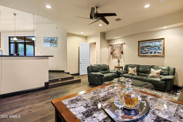 living area with wood finished floors, visible vents, and recessed lighting