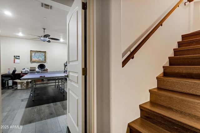 stairs with hardwood / wood-style floors, recessed lighting, visible vents, and a ceiling fan