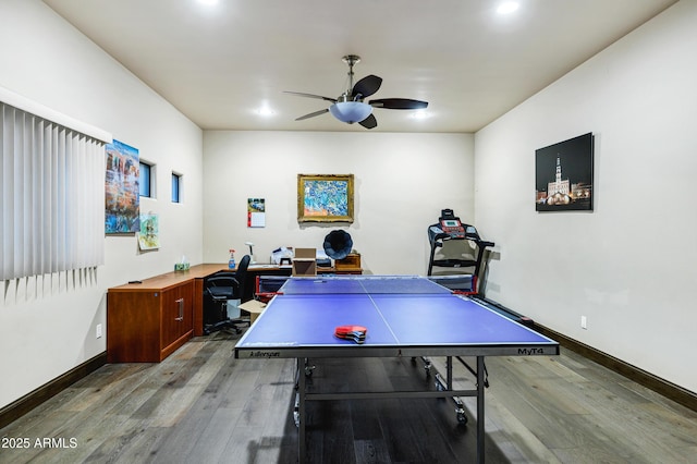 recreation room featuring wood-type flooring, ceiling fan, and baseboards