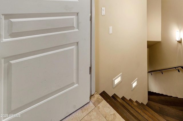 staircase featuring tile patterned flooring