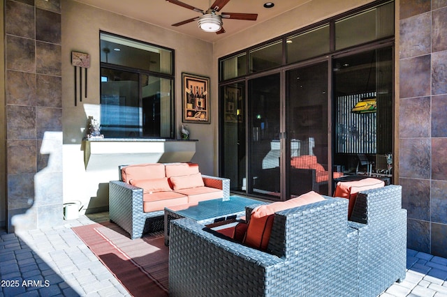 view of patio featuring an outdoor living space and a ceiling fan