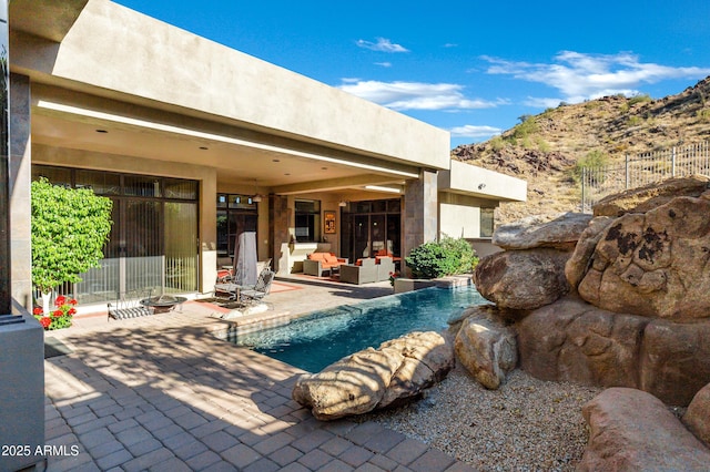 outdoor pool featuring a patio area and an outdoor hangout area