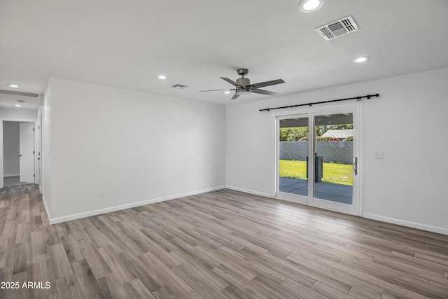 empty room featuring light hardwood / wood-style flooring and ceiling fan