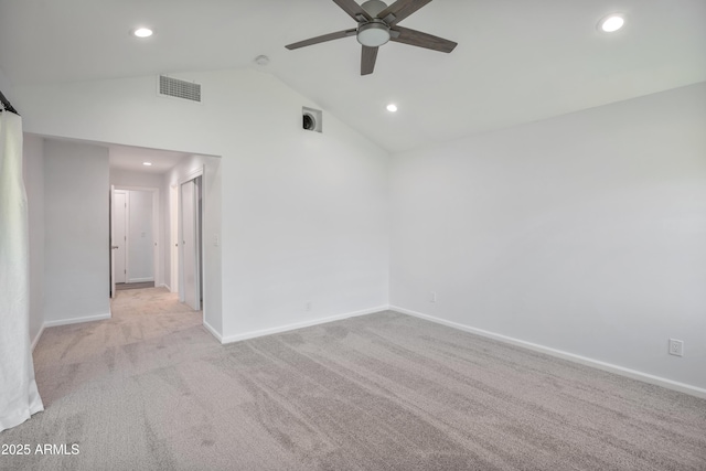 carpeted empty room with ceiling fan and lofted ceiling