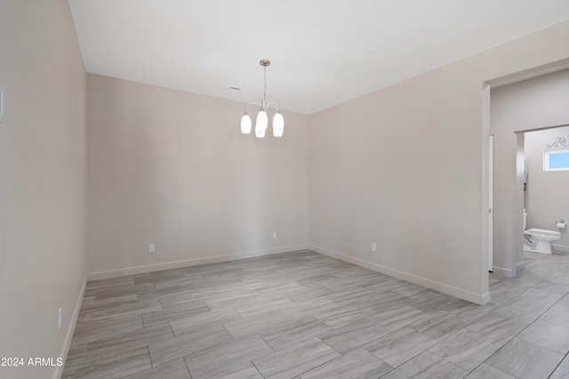 empty room with an inviting chandelier