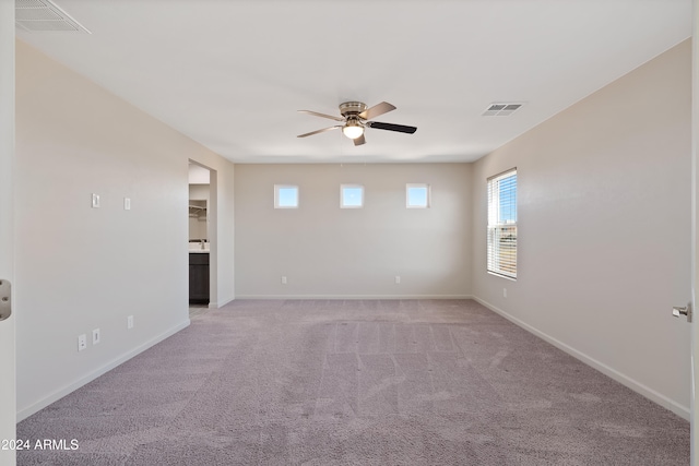 carpeted empty room featuring ceiling fan