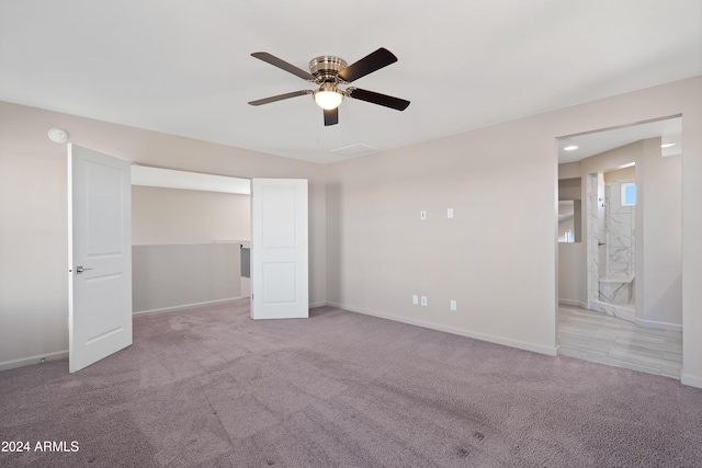 carpeted spare room featuring ceiling fan