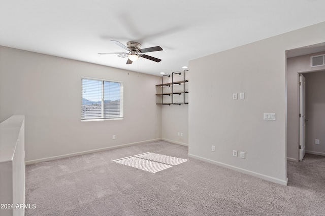 carpeted empty room featuring ceiling fan