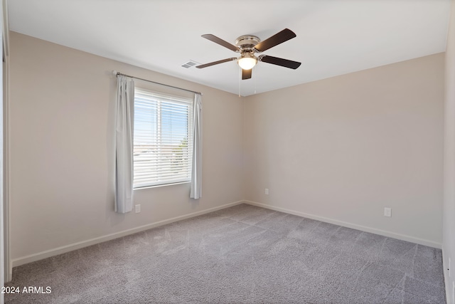 unfurnished room with ceiling fan and carpet