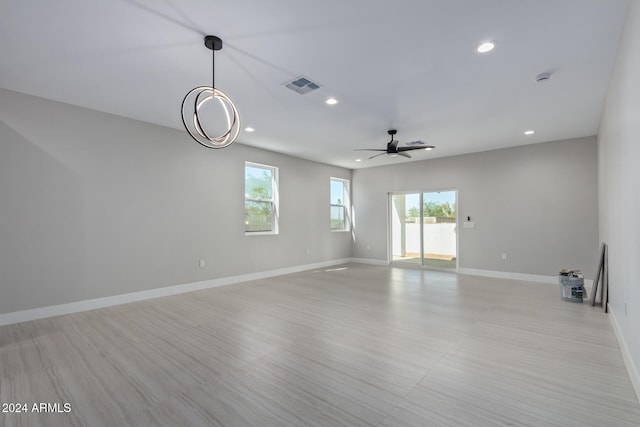 unfurnished room featuring light hardwood / wood-style floors, ceiling fan, and a wealth of natural light