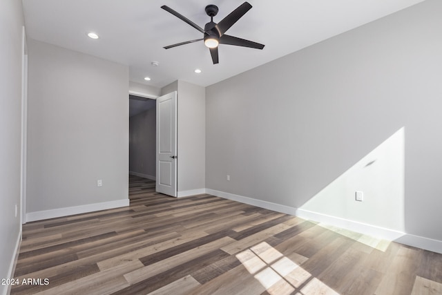 unfurnished room with ceiling fan and dark hardwood / wood-style flooring