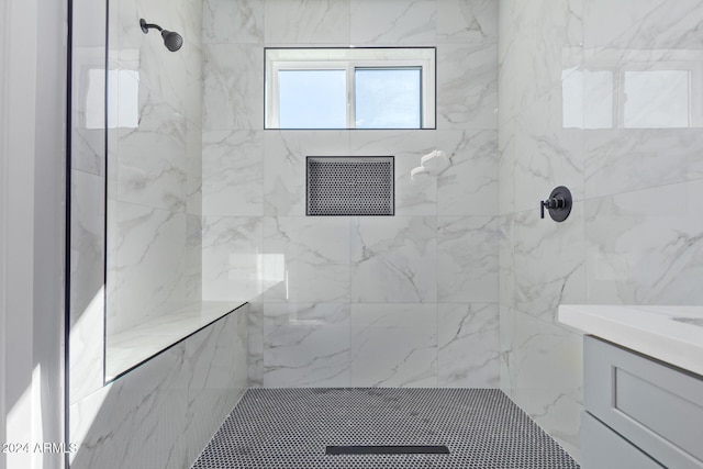 bathroom featuring vanity and a tile shower