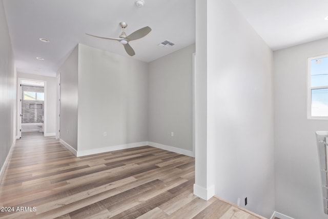 empty room with light hardwood / wood-style floors and ceiling fan