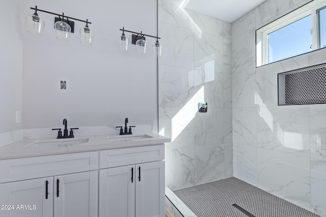 bathroom with vanity and tiled shower