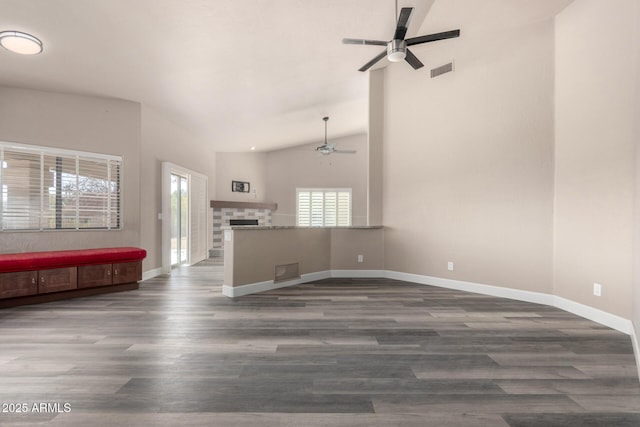 unfurnished living room with ceiling fan, dark wood finished floors, and visible vents