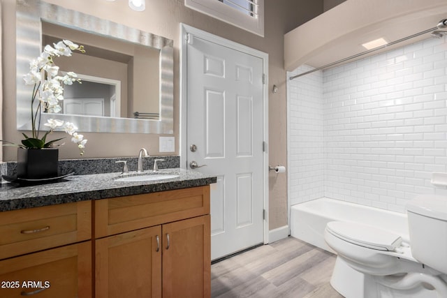 full bathroom featuring toilet, shower / tub combination, wood finished floors, and vanity