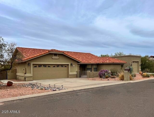 view of front facade with an attached garage, driveway, and stucco siding