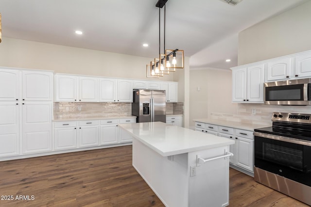 kitchen featuring white cabinets, appliances with stainless steel finishes, a kitchen island, and pendant lighting