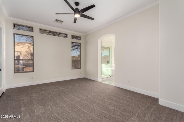 unfurnished room with ceiling fan, dark carpet, and crown molding